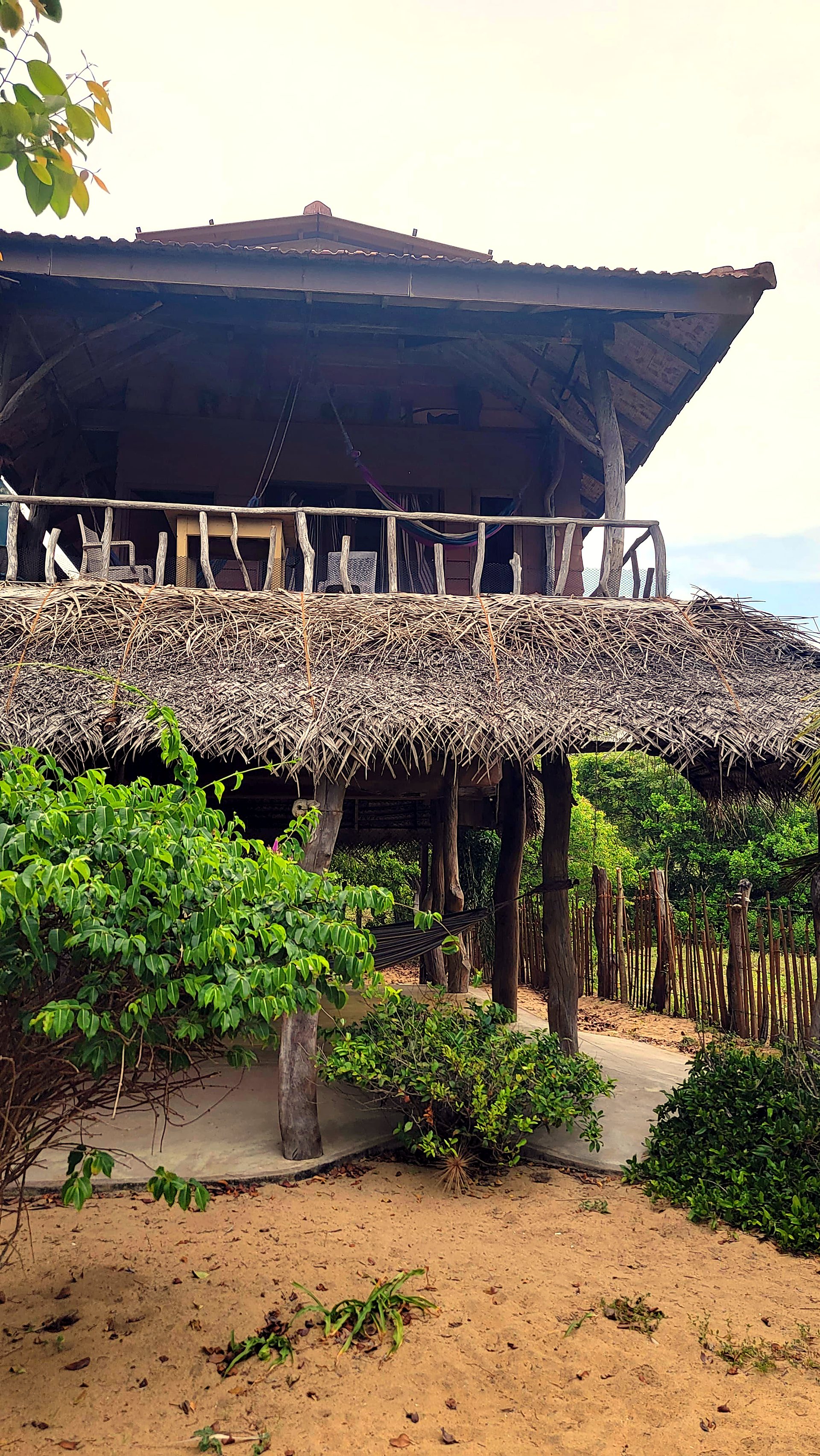 Two-storey thatched cabana among the trees