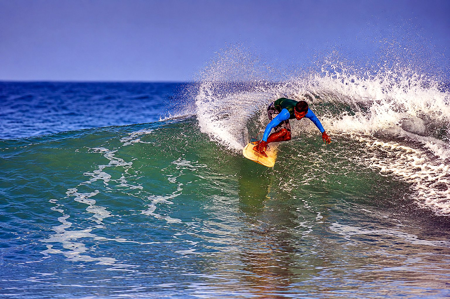 A surfer riding a wave at Arugam Bay