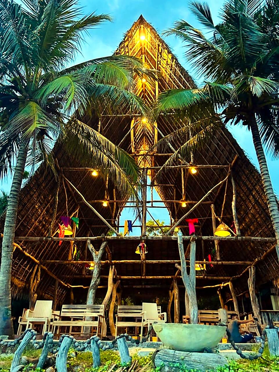 Inside the natural-wood A-frame restaurant lit at golden hour